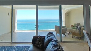 A spacious balcony with a view of the ocean, a leather sofa, and wicker furniture. - Fantastic view!!!! Romantic setting (Rosarito Beach)
