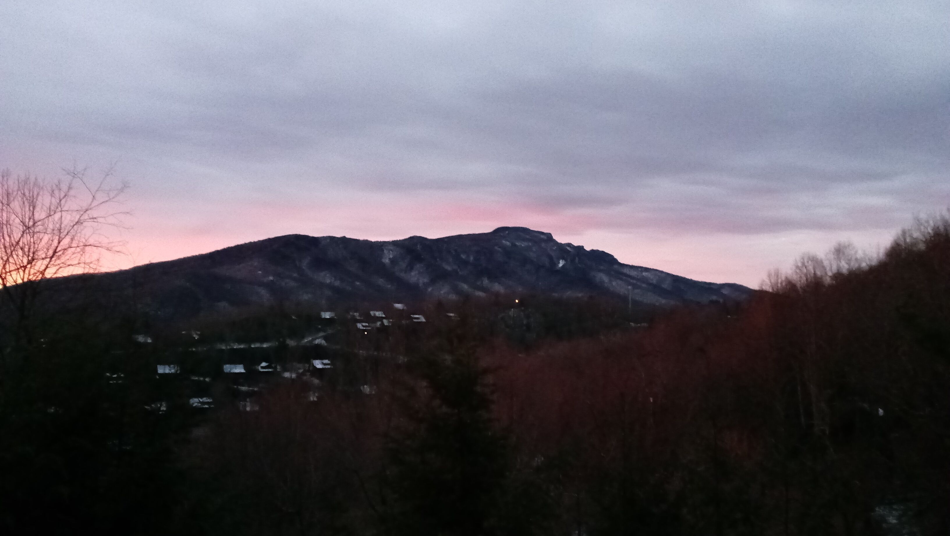 A mountain range with a sunset in the background.