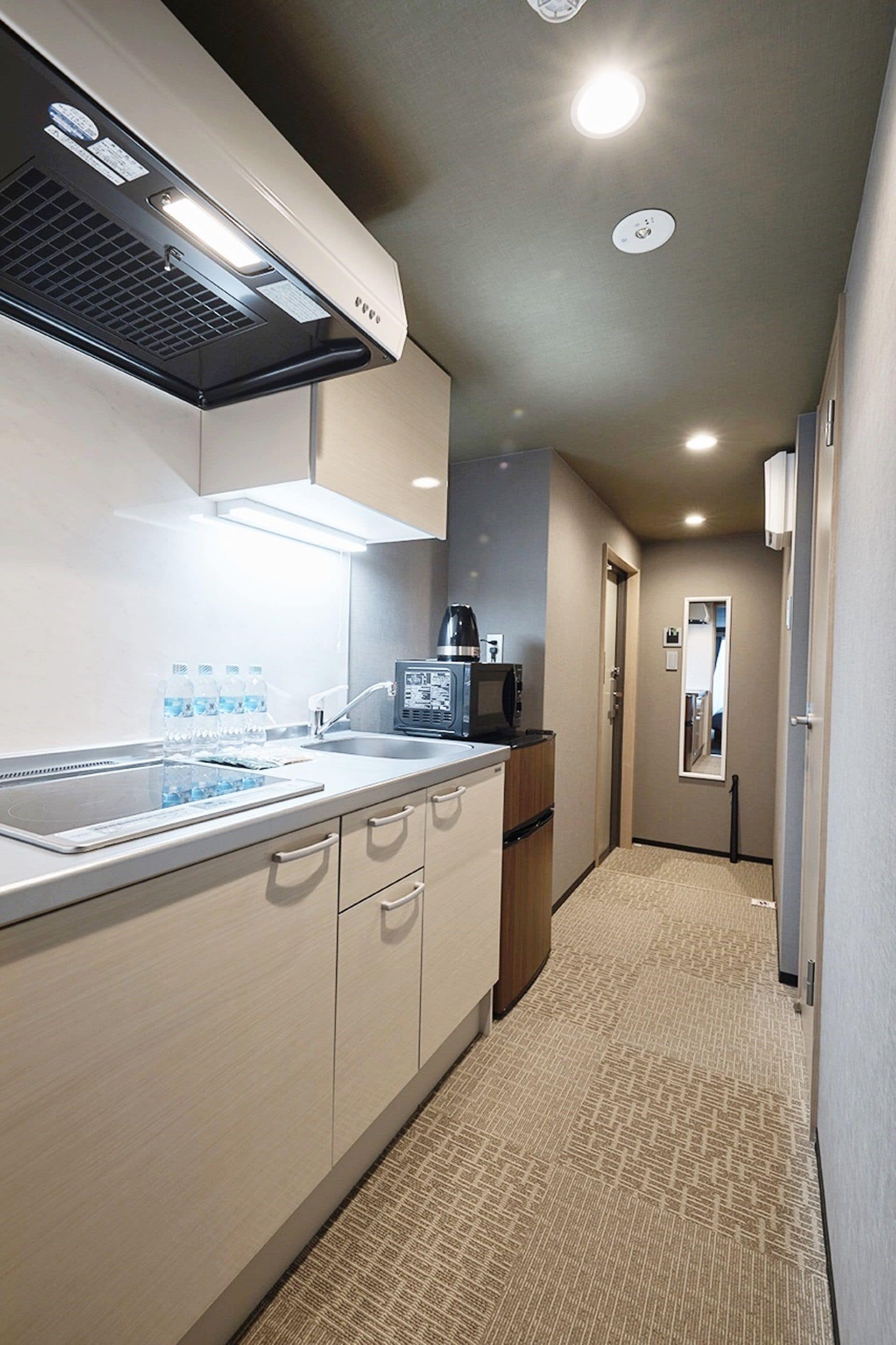 A modern kitchen with a microwave, sink, and cabinets.