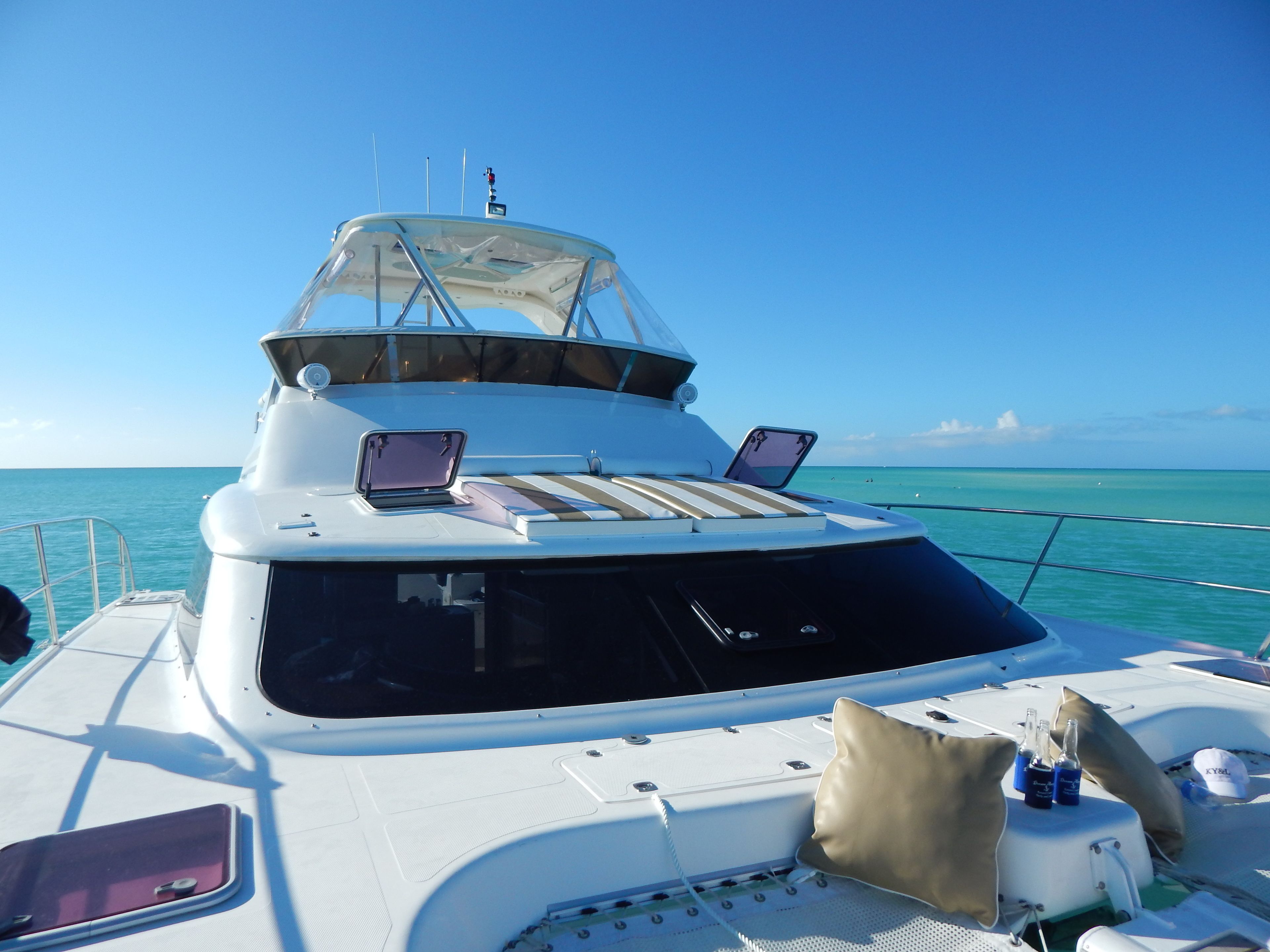 A yacht with a covered deck area, two laptops, and a cushion.