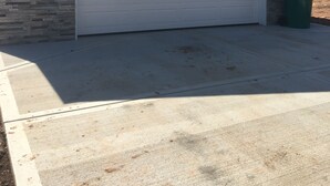 A garage with a white door, a stone base, and a green trash bin. - Perfect get away that is minutes from Legendary Downtown Sturgis! (Sturgis)