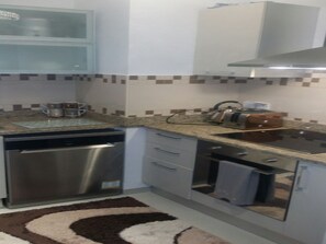 A modern kitchen with stainless steel appliances, a microwave, and a toaster.