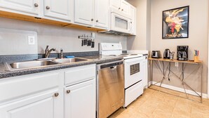 A modern kitchen with white cabinets, stainless steel appliances, and a granite countertop. - Insta Worthy Stay! - Fun in Downtown Raleigh! (Raleigh)