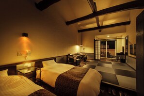 A hotel room with two beds, a massage chair, a small table, and a mirror. - Hoozue No Toki (Izu)