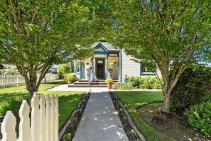 A house with a front porch, a mailbox, and a small garden.
