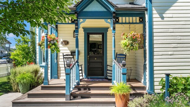 A two-story building with a front porch, a black door, and a number '801' sign. - Victorian Secrets 1897 Home - Curious? Eclectic, convenient & ❤️ of wine country (Newberg)