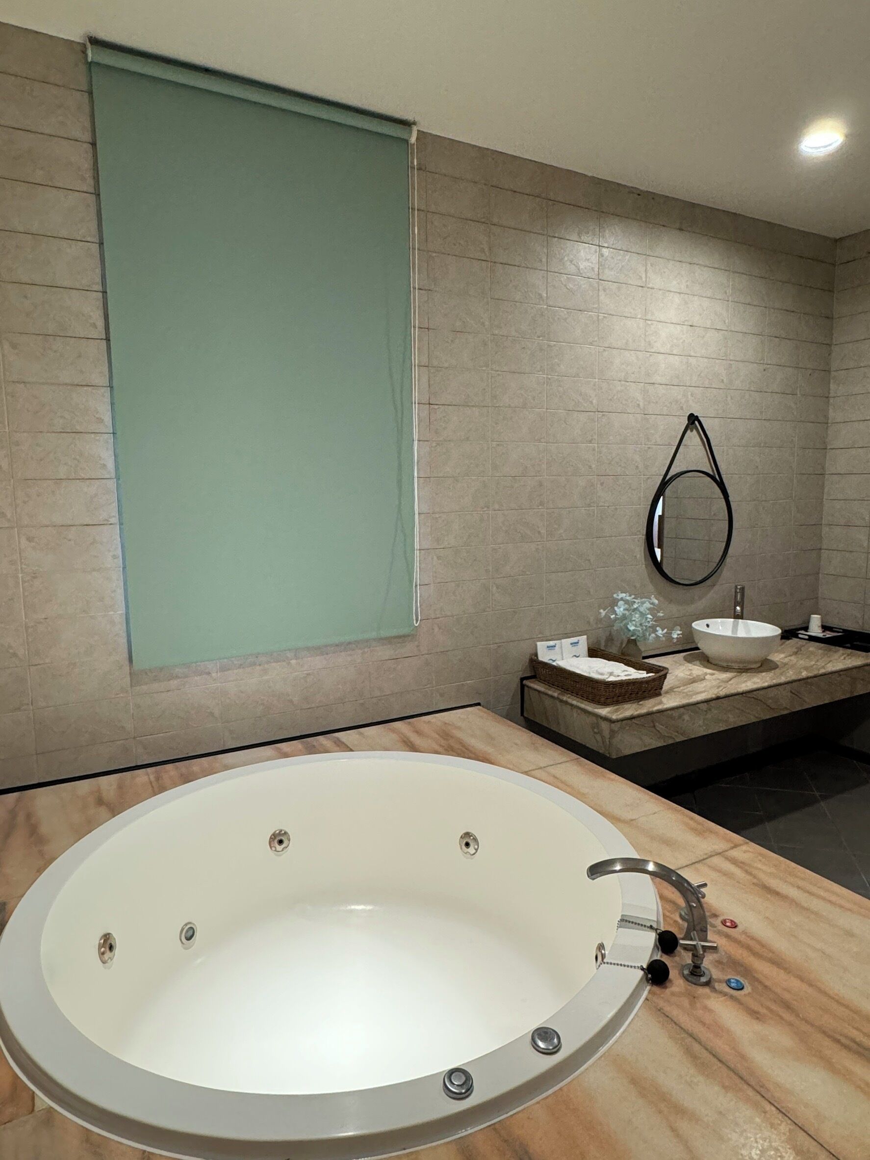 A modern bathroom with a freestanding bathtub, a sink, and a mirror.