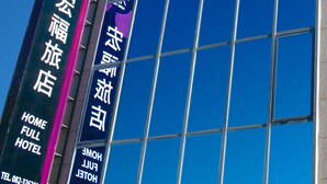 A hotel with large glass windows and signage indicating it is a "Home Full Hotel". - Home Full Hotel (Jincheng)