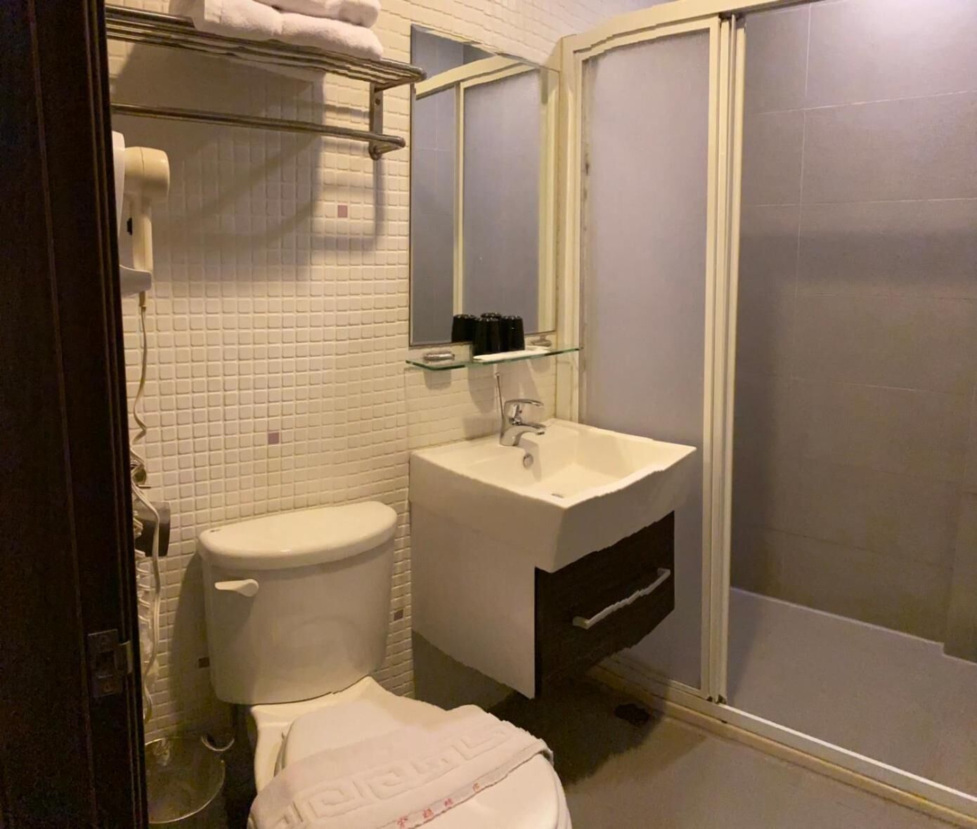 Shower, hair dryer, slippers, towels