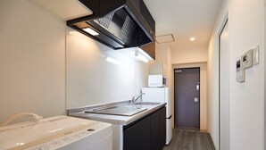 A compact kitchen with a microwave, a sink, and a dishwasher.