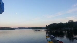 A calm lake with a dock and rowboats.