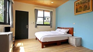 Un dormitorio con una cama de madera, una mesita de noche, una ventana con cortinas y un cuadro en la pared.