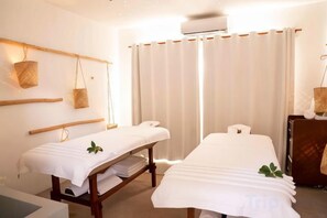 A room with two beds, a wooden bench, a wall-mounted basket, and a curtain. - Veranda Tamarin Hotel and Spa, 3 Star (Mauritius)