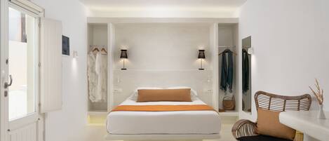 A modern bedroom with a large bed, a chair, and a wardrobe.