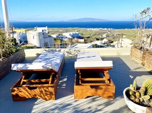 Relax on the terrace with comfortable loungers and enjoy the scenic coastal view.
