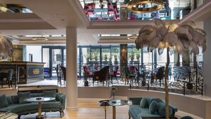 A spacious lobby with a high ceiling, ornate chandeliers, and a grand staircase. - Paris j'Adore Hotel & Spa (Paris)