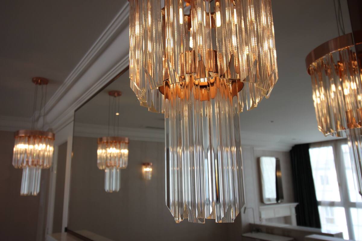 A chandelier with multiple light fixtures hanging from the ceiling.
