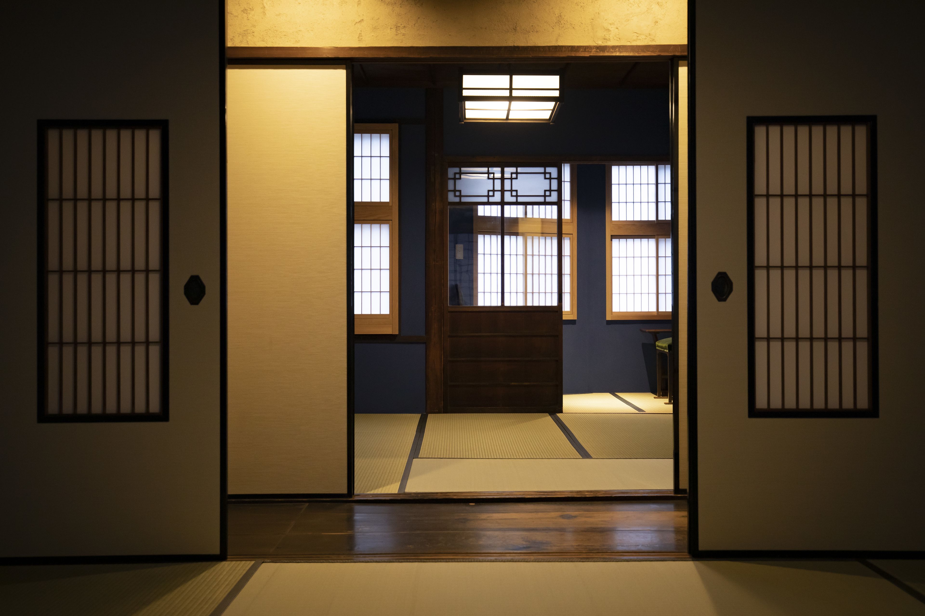 A traditional Japanese room with tatami flooring, sliding doors, and shoji screens.