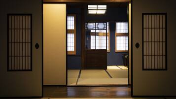 A traditional Japanese room with tatami flooring, sliding doors, and shoji screens.