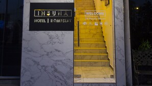 A hotel entrance with a marble facade, a sign reading "HOTEL INSUNA," and a welcome sign for a 24-hour room. - Hotel Insuna (Johor Bahru)