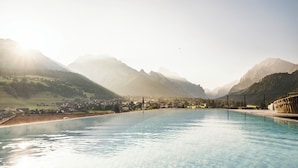 A swimming pool with a view of mountains and a town.
