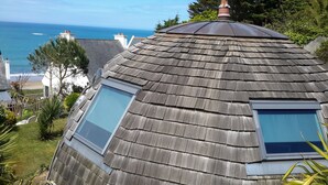 A house with a sloped roof, two skylights, and a view of the ocean. - Original round wood house T3 sea view (Locquirec)