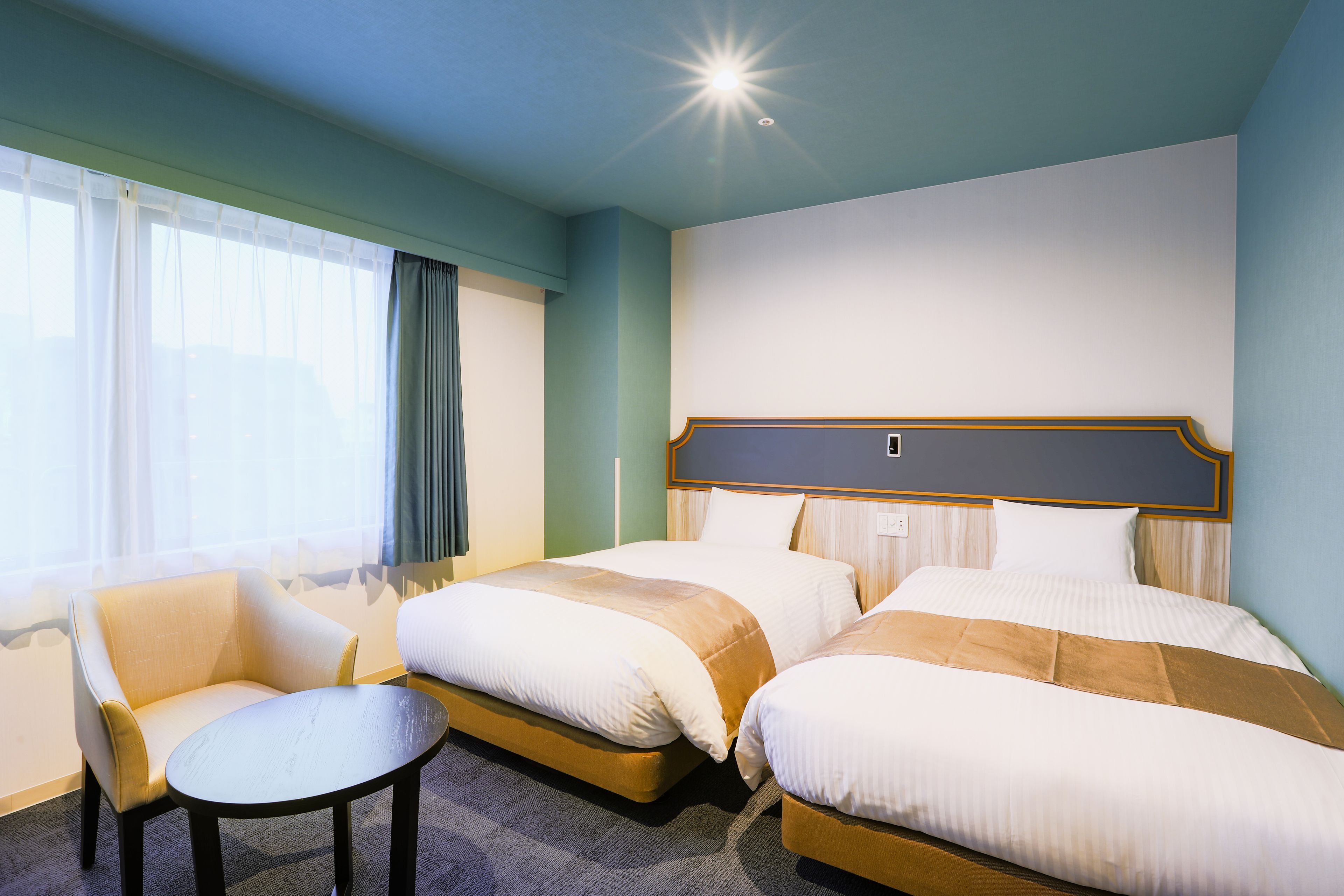 deluxe twin room | desk, laptop workspace, blackout curtains, soundproofing