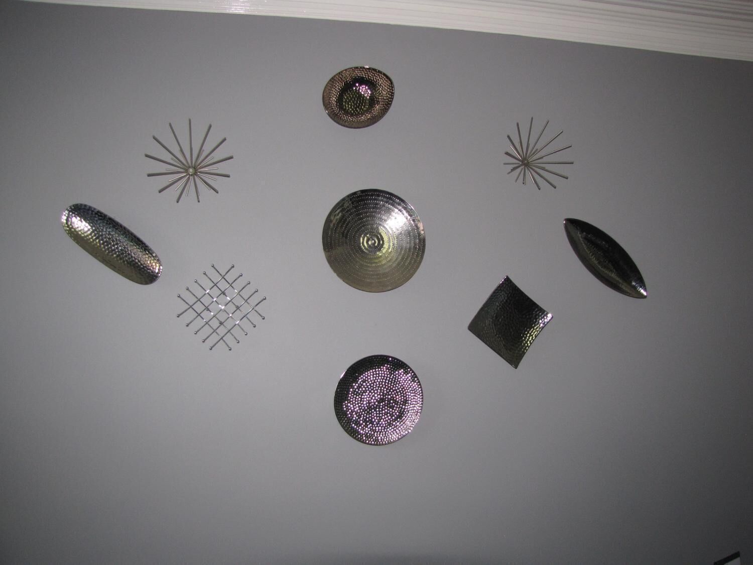 A ceiling with various geometric metal objects.