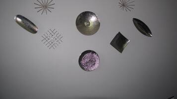 A ceiling with various geometric metal objects.