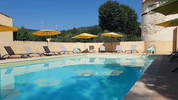 Seasonal outdoor pool, open 9:30 AM to 7:30 PM, pool umbrellas