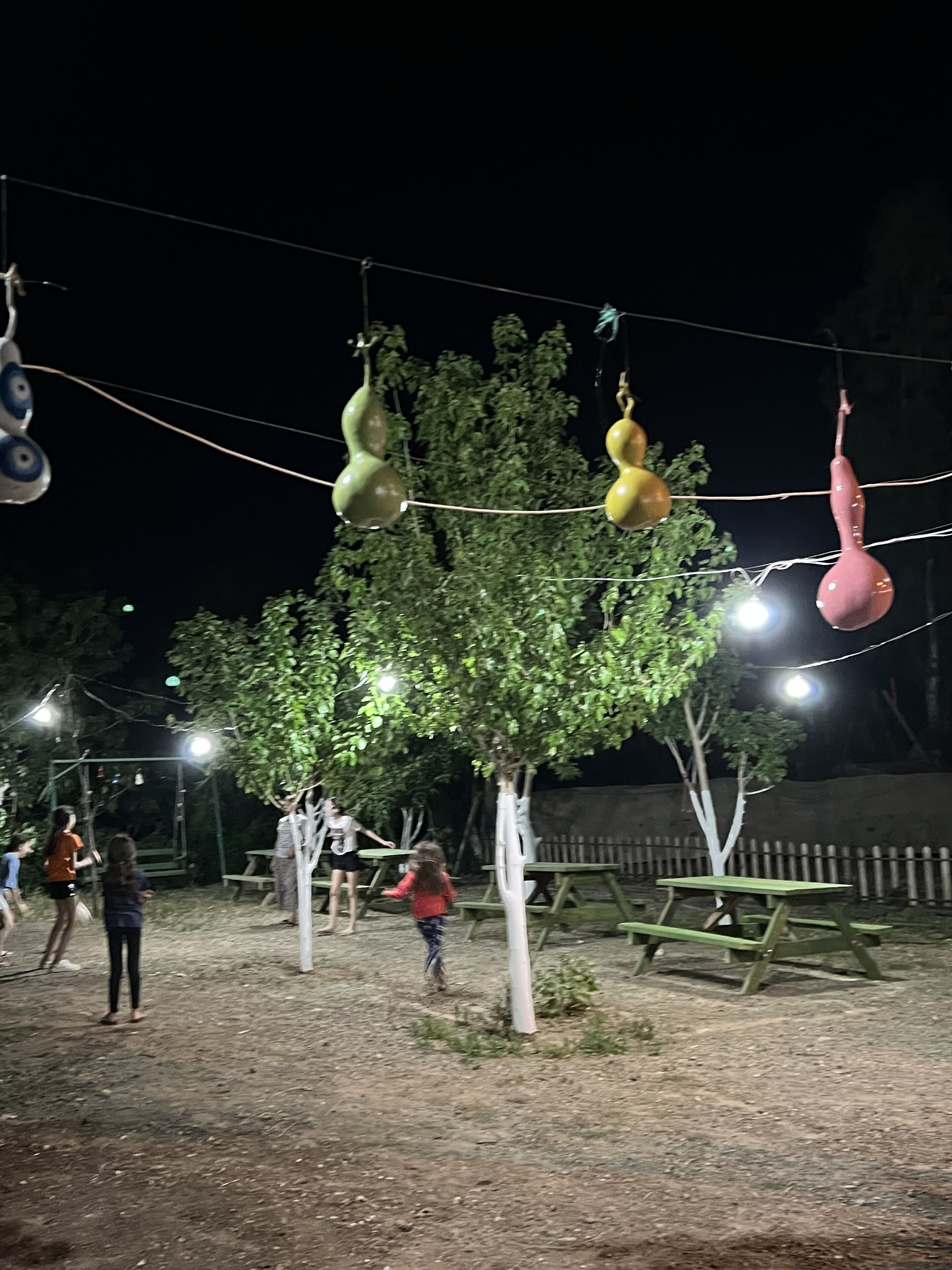 A playground with swings and a picnic table area.