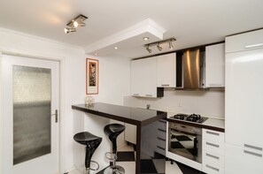 Apartamento, 1 quarto, vista para o jardim | Cozinha privada | Geladeira, micro-ondas (mediante solicitação), fogão, cooktop
