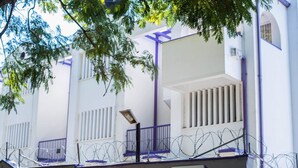 A building with a sign reading "EDEN VILLAS" and a street address. - Eden Villas (Harare)