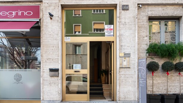 A building with a storefront labeled "egrino" and a "Ducati Case" sign. - Flatty Apartments - Alserio (Milan)