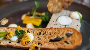 A plate with various food items including bread, corn, and eggs.