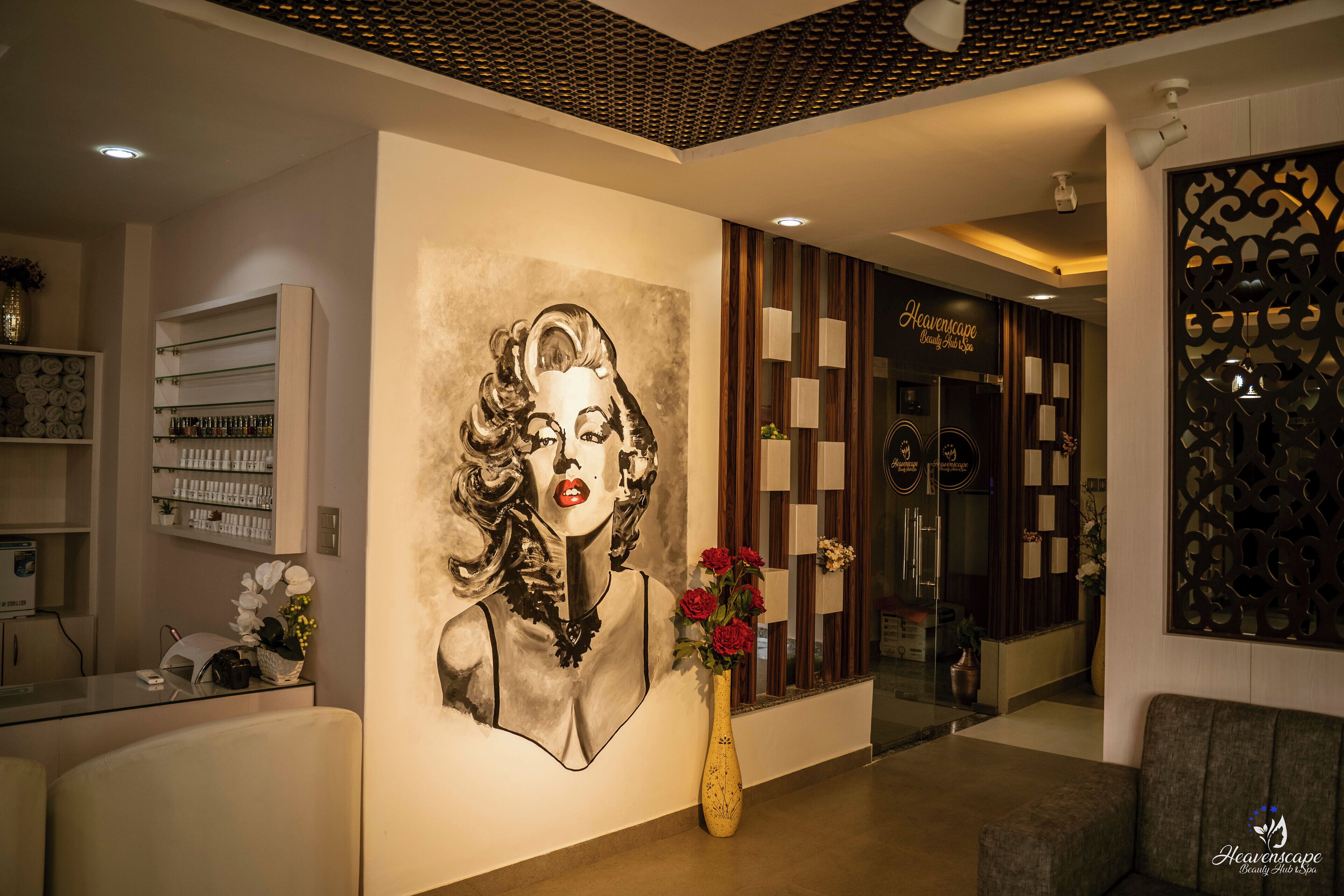 A modern interior with a large wall mural, a reception desk, and a reception area with a decorative panel.