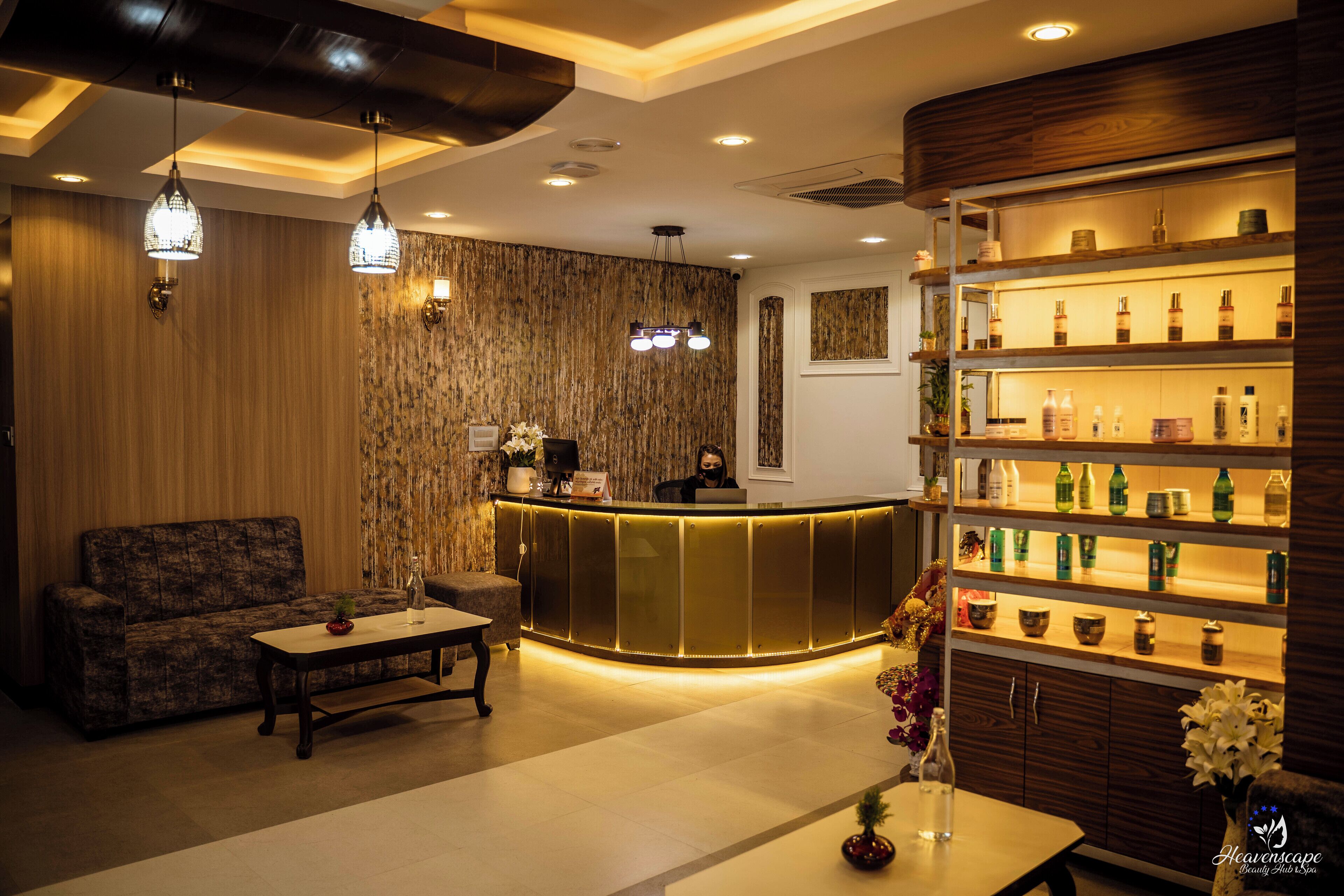 A reception area with a wooden reception desk, a sofa, a coffee table, and a shelf with various items.