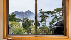 A bedroom with a large window overlooking a mountainous landscape and a body of water. - Greystone (FS5) - Freycinet Holiday Houses (Coles Bay)