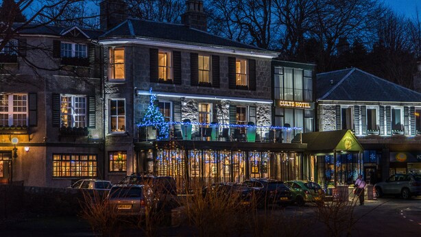 A historic building with a restaurant on the ground floor, multiple windows, and a Christmas tree. - Cults Hotel (Aberdeen)