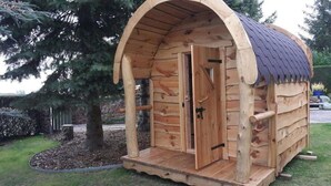 Une cabane en bois avec un toit à deux versants, une porte et un petit porche.