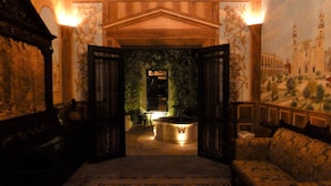 An interior with a reception desk, a patterned carpet, and a mural of a building. - Stay in Mérida's Grand Colonial Mansion w/ Private Pool (Centro)