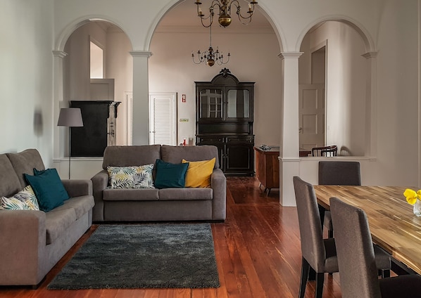 Relax in this inviting living area with a comfortable sofa, dining table, and stylish storage cabinet.