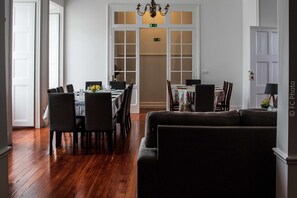 Enjoy meals with friends and family in this spacious dining area, complete with a long table and comfortable seating.