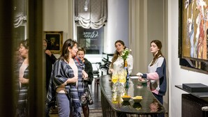 A group of people standing around a bar area with a painting on the wall and a sign that reads "JUDITH & KATE". - B&B Kwaadham 52 - Music Hotel Ghent (Ghent)