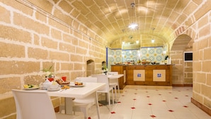 Un restaurante con paredes de ladrillo, suelo de baldosas y una barra con protección de azulejos.