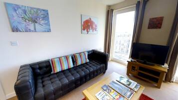 Apartment, 1 Double Bed, City View | Living area | Flat-screen TV, DVD player