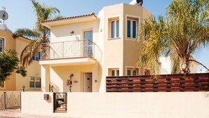 A two-story building with a balcony, a satellite dish, and a gated entrance. - Natalie Villa CL 41 (Paralimni)