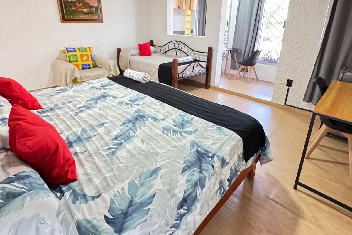 Ein Schlafzimmer mit einem Bett, einem Schreibtisch und einem Stuhl.