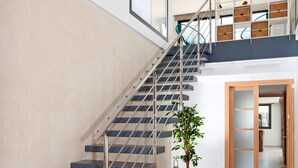 A modern staircase with metal railings and blue steps leading to a second floor. - COZY HOLIDAY VILLA IN THE HEART OF MALLORCA (Sa Pobla)