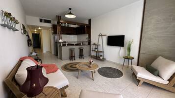 Superior Apartment, Oceanfront | Living room | Flat-screen TV